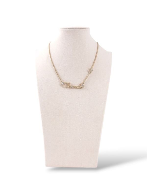Collier Chanel Champagne Écriture Chanel Avec Étoiles Strassées Et Pendentif Double CC